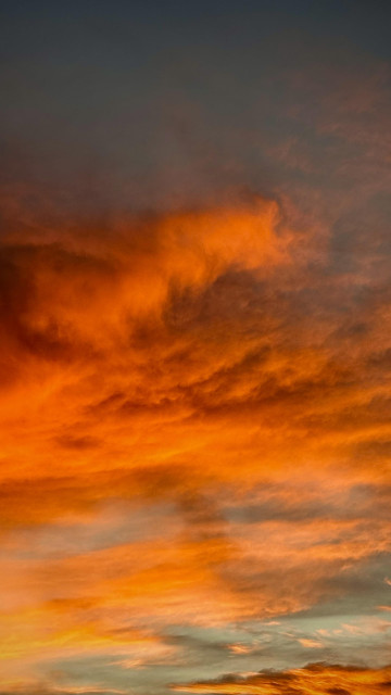 Clouds glowing orange and hints of red and yellow at sunset