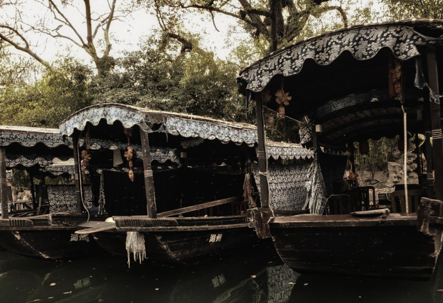 Covered barges lined up on the river.