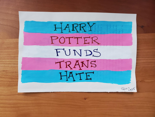 A trans flag painted on pages torn from a harry potter book. Overtop is the text, Harry Potter Funds Trans Hate.