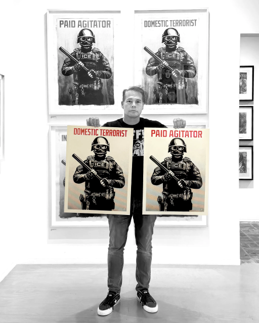 The image shows a person holding prints of an ICE agent, one reads Domestic Terrorist, the other Paid Agitator.