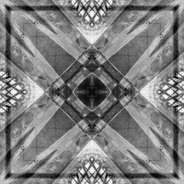 Kaleidoscope-like black and white digital art created from one of my own photographs. The background looks like a rough stone floor, and in the centre there are squares interlocking at one corner to form various patterns. Lighter stripes taper towards the corners, and along the sides there are what look like barred windows.