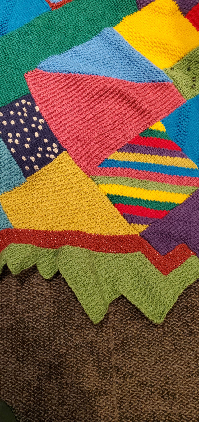 Closeup of multicoloured crocheted afghan work in progress
