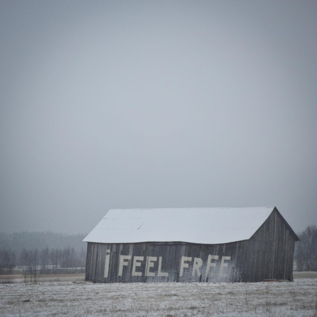 Snow covered barn on a field