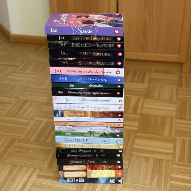 A stack of 24 books by Jae, with the newest one, Sparks, on top. 