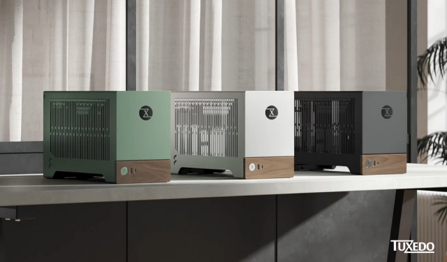 three tuxedo atlas s in green, white and black on an office bench. grey curtains in the background and a dark grey couch behind the atlas s. 