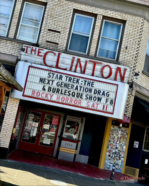 Photo of a light brick building, with the Clinton theater marquee announcing Star Trek Drag and Burlesque and the Rocky Horror Picture Show