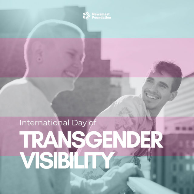 An image of two men smiling on a roof terrace with the colours of the trans flag over the image. 

Words read: International Day of Transgender Visibility. Newsmast Foundation.