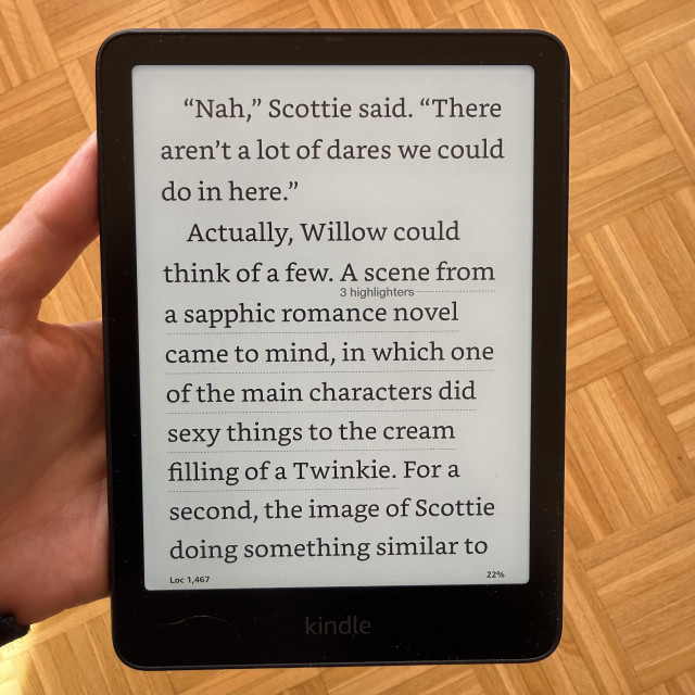 Depicted is a hand holding a Kindle Paperwhite showing the following quote from Sparks by Jae: 

“Nah,” Scottie said. “There aren’t a lot of dares we could do in here.”

Actually, Willow could think of a few. A scene from a sapphic romance novel came to mind, in which one of the main characters did sexy things to the cream filling of a Twinkie. For a second, the image of Scottie doing something similar to one of the Oreos left in the pack rose to the forefront of her mind’s eye. Heat prickled up the back of her neck.