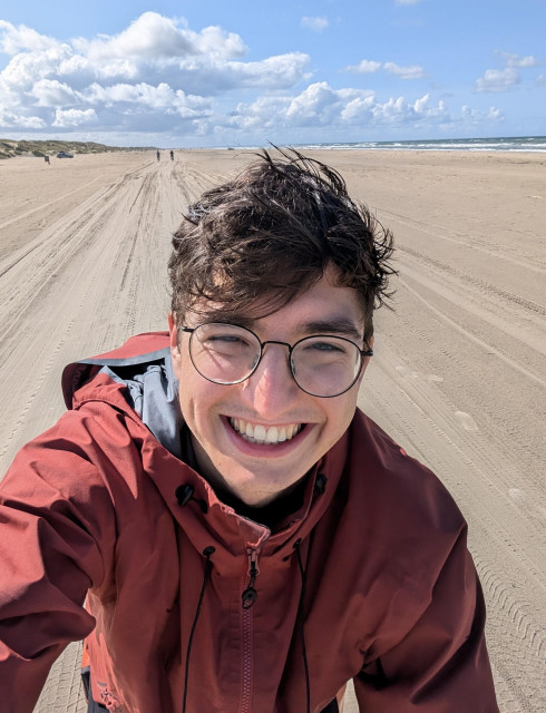 Picture of me riding my bike on a beach in Denmark on a beautiful sunny day.