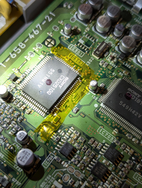 Showing the internals of this PS1, CD processor chip with 4 pins lifted, polyamide tape down to prevent contact