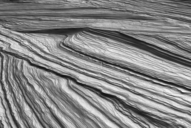 an abstract close up black and white photograph of streaking lines of gypsum running diagonally across the frame