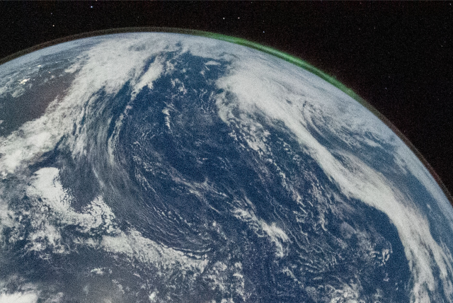 Closeup of the antarctic side of the Blue Marble image in post #37.
Shows green aurora and a thin line at the top of Earth's atmosphere.