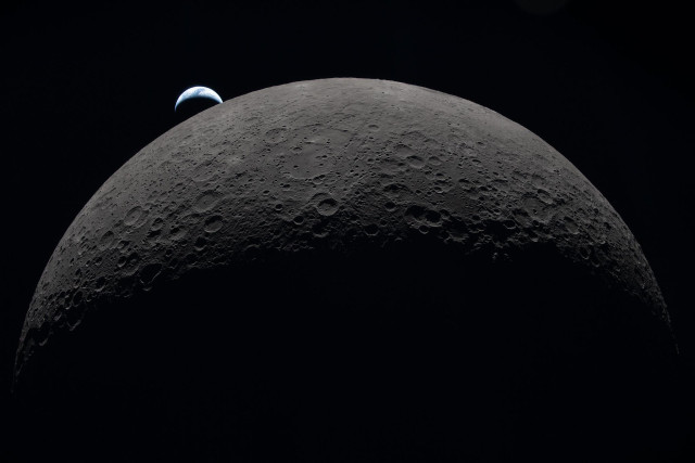 (copy of the original description)
art002e009287 (April 6, 2026) – Earth sets at 6:41 p.m. EDT, April 6, 2026, over the Moon’s curved limb in this photo captured by the Artemis II crew during their journey around the far side of the Moon. Orientale basin is perched on the edge of the visible lunar surface. Hertzsprung Basin appears as two subtle concentric rings, which are interrupted by Vavilov, a younger crater superimposed over the older structure. The lines of indentations are secondary crater chains formed by ejecta from the massive impact that created Orientale.

 

The dark portion of Earth is experiencing nighttime. On Earth’s day side, swirling clouds are visible over the Australia and Oceania region. Credit: NASA