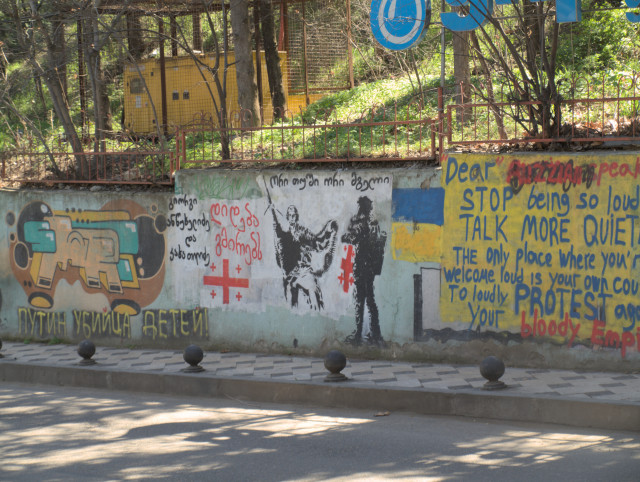 Political painting on a wall with message:
Dear Russian speaker Stop being so loud!
Talk more quietly.
The only place where you're 
welcome loud is your own country
to loudly protest against 
your bloody Empire!
