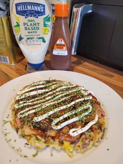 A vegan okinomiyaki on a plate ready to be served