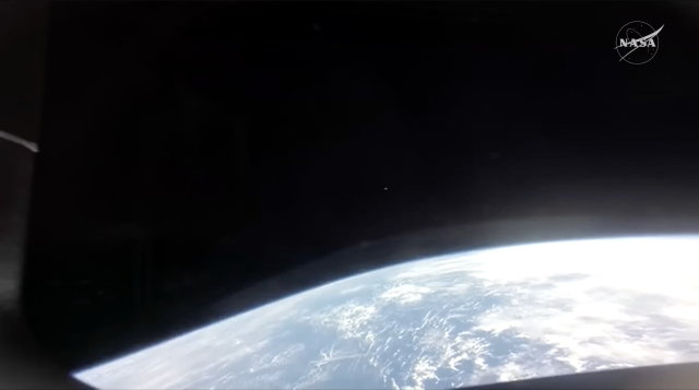 earth seen from something close to orbit from integrity, a big curve of earth along the bottom of the window, no longer visible as a globe