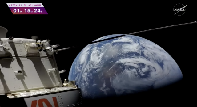 Shot from the Artemis's outboard camera, the ship on the left, a section with side instruments mostly visible and the bottom of the N and A from NASA just peeking up from the bottom, upside down. Beyond the ship, the earth, half lit, the light side up in the photo, lots of clouds and land and ocean. You know, the Earth.