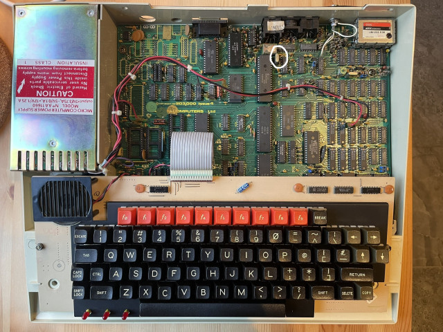 BBC Micro with the cover off. The X1 oscillator is circled in white.