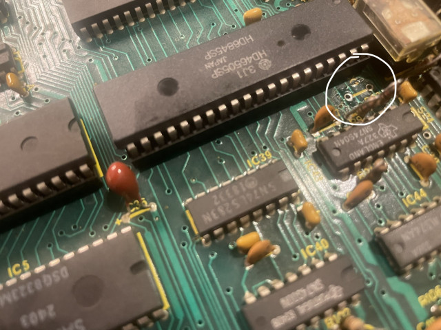 So this is where the old crystal oscillator was. There was some yellowish-brown residue under it that I cleaned up with a cotton-tip.