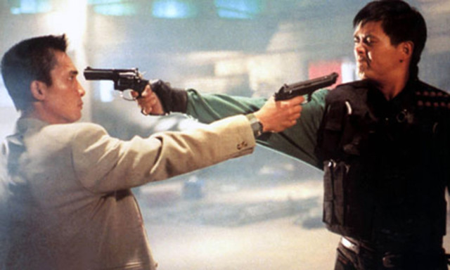 Two tough looking humans holding guns to each other's heads.