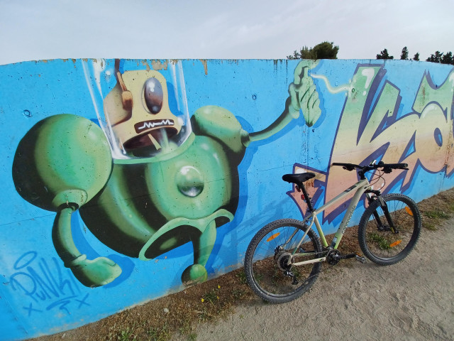 A robot painting in green