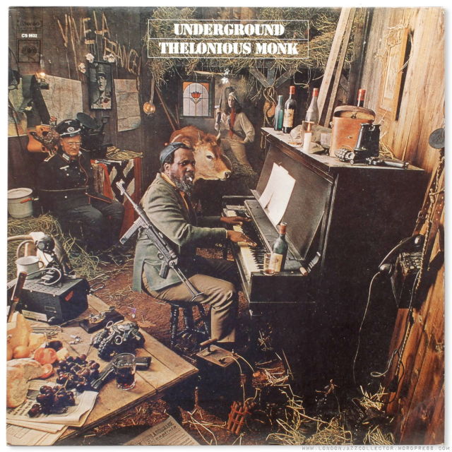 Image shows Monk’s Underground album.  Monk is sitting at a dusty piano in a barn with a cow in the background.  He has a sub-machine gun hanging from his right shoulder.  in the left background a Nazi officer is sitting in a chair tied with a rope around his torso and his hands bound behind his back.  There is a table in the foreground with bread, grapes, cheese, and a shot glass of alcohol but additionally a 45 caliber handgun, multiple grenades and a radio set with Morse code clicker.  There are several bottles have half drunk liquor on the piano as well as binoculars, a binocs case, another handgun, and grenades.  On the far wall are maps and a photo of Charles de Gaulle. 