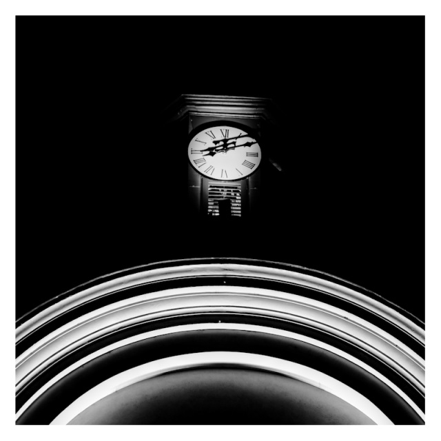 A clock in the darkness, orbiting the rings of a distant planet.