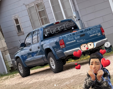 From @NeurodivergentRebel on Ig, a picture taken in Texas shows a blue Dodge Dakota pick truck with FUCK ICE written across the back window. All over the rest of the car are slogans like "FUCK TRUMP" "FUCK DHS" and "FUCK ICE." In the lower right hand corner is a digital drawing of a person with hearts floating the air around them.
