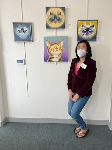Joy at a solo exhibition in her hometown, displaying her cat paintings.