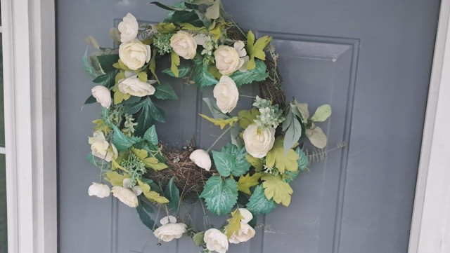 the nest, as it sits in a wreath on a door