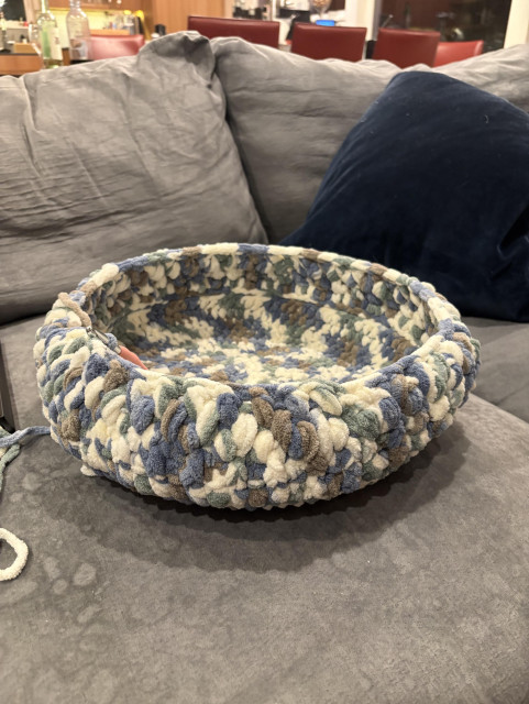 Round bowl like cat bed made from blue white and gray fleecy yarn