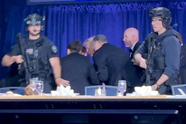 President Donald Trump is escorted after a shooting during the annual White House Correspondents' Association dinner in Washington, D.C., on Saturday. (Bo Erickson / Reuters) © Bo Erickson