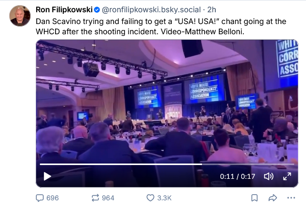 Ron Filipkowski says "Dan Scavino trying and failing to get a 'USA! USA!' chant going at the WHCD after the shooting incident. Video-Matthew Belloni."

Video still shows the room with a bunch of bootlickers sitting in silence as this fool yells "USA!"
