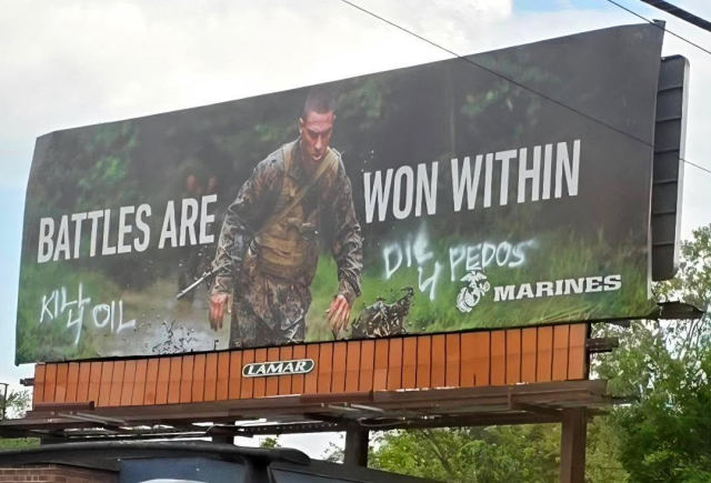 A US Marine recruiting billboard defaced with "Kill 4 OIl" and "Die 4 Pedos."