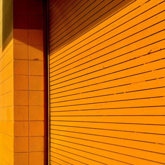 Orange garage door on a building painted in the same orange