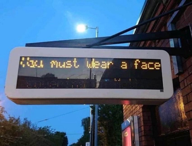 An LED transit message sign saying “you must wear a face”