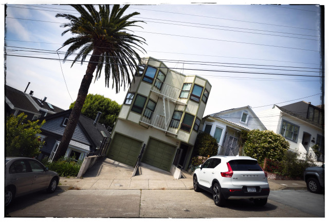 Fulfilling an annual requirement (it's the law!), here is a picture of a row of houses on a steep hill, San Francisco style. Created by tilting the camera until the street and parked cars are horizontal, the houses appear tilted, leaning into each other for support. In fact the greenish three story condo building in the center of this picture looks particularly drunk. But hey, it's Friday and the cocktail hour approaches.