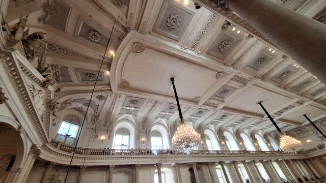 The ceiling of a wide room or hall, richly decorated