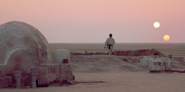 Luke Skywalker looking at the sky on Tatooine, where there are two suns