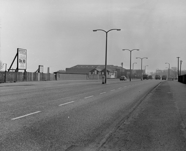 b/w street photo including film poster for: Dr. No