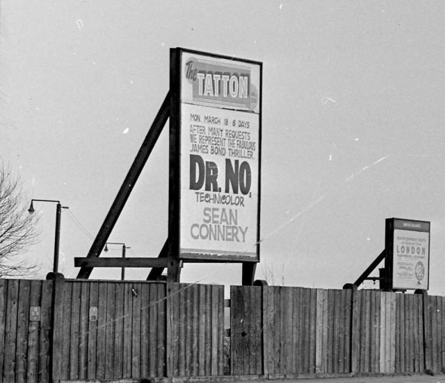 b/w street photo including film poster for: Dr. No (close up)