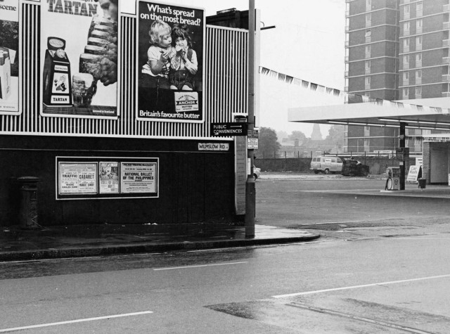 b/w street photo including film poster for: Traffic / Cabaret / Where Eagles Dare / Midnight Cowboy 