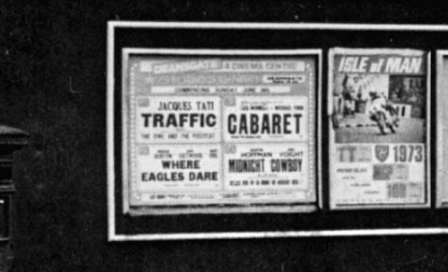 b/w street photo including film poster for: Traffic / Cabaret / Where Eagles Dare / Midnight Cowboy  (close up)