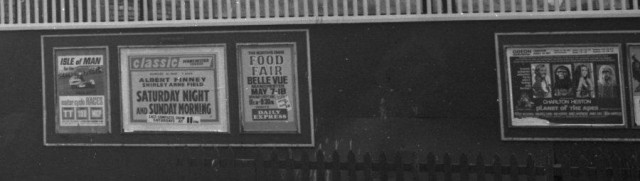 b/w street photo including film poster for: Saturday Night and Sunday Morning / Planet of the Apes  (close up)