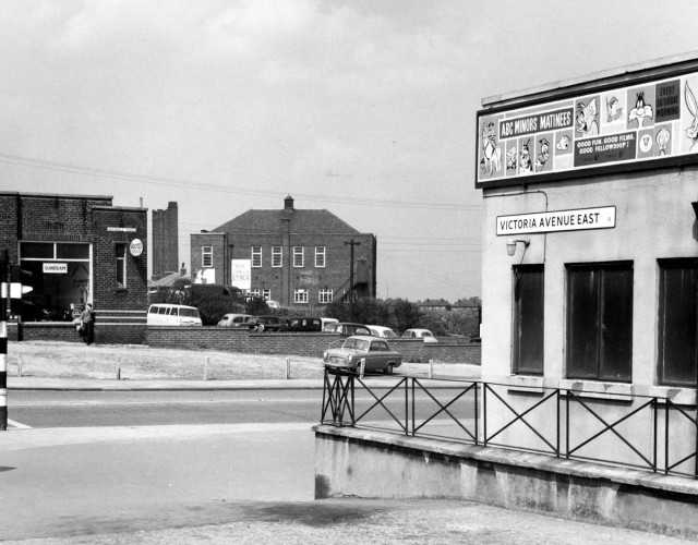 b/w street photo including film poster for: ABC Minors Matinees 