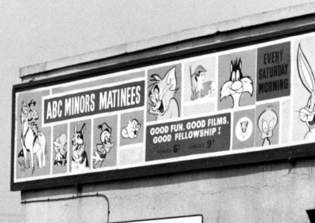 b/w street photo including film poster for: ABC Minors Matinees (close up)