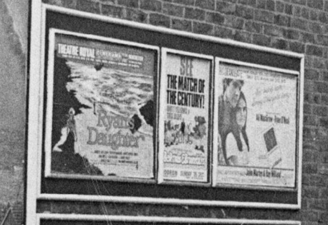 b/w street photo including film poster for: Ryan's Daughter / Love Story  (close up)