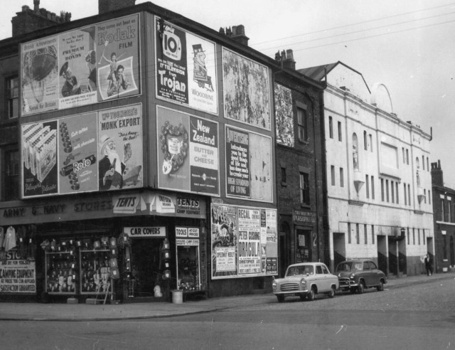 b/w street photo including film poster for: Dracula / The Fly 