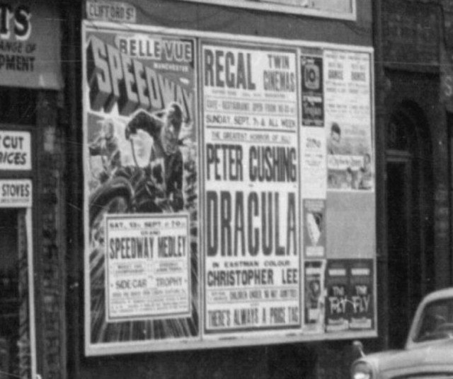 b/w street photo including film poster for: Dracula / The Fly (close up)