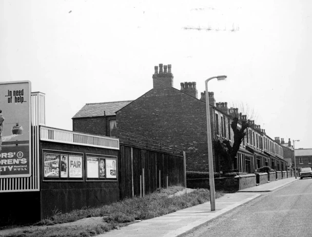 b/w street photo including film poster for: Dr. Who & the Daleks / A Shot in the Dark  